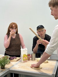 a group of people preparing food in a kitchen